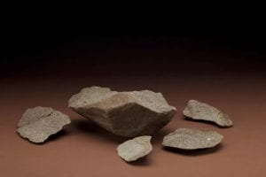 Pictured is a set of stone flakes that were removed from the stone core sitting in the center of the set. 