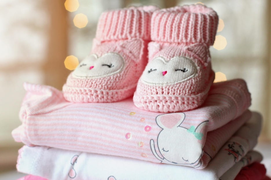 [Pink baby clothes and pink baby shoes.]