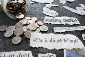 Cup with change spilled out with the question on paper asking, "Will Your Social Security Be Enough?"