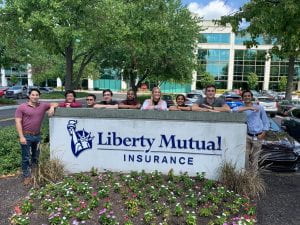 Interns standing in front of Liberty Mutual Sign in Indianapolis, IN Office